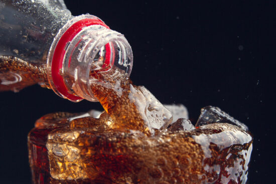serving-cola-from-bottle-glass-full-ice