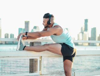 Man stretching his legs wearing headphones