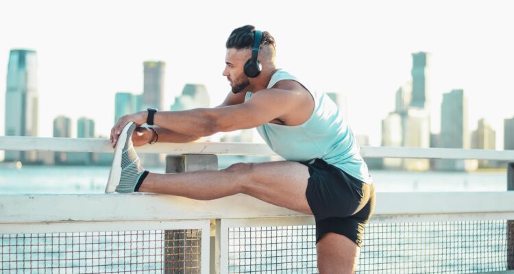Man stretching his legs wearing headphones